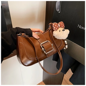 Brown retro underarm bag with large metal buckle and cute plush bear charm detail