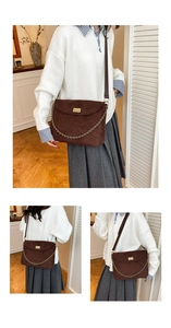 Detail of dark brown quilted suede tote bag with gold twist lock and chunky chain