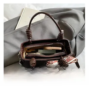 Overhead view of brown vintage bucket bag with multiple compartments and inner zippers