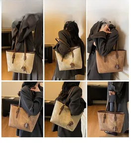 Detailed views of vintage large tote bag in beige and brown with elephant charm