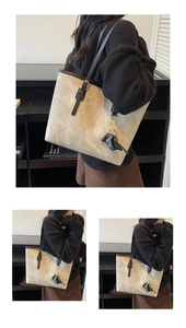 Macro shot of khaki vintage tote bag with black trim and cute elephant charm detail