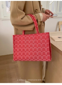 Detail of red bridal tote bag with Xi characters jacquard and minimalist retro vibe