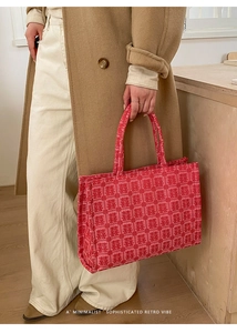 Close-up of red Chinese wedding tote bag with traditional double happiness embroidery