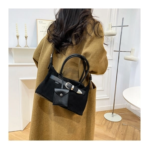 Detail of black faux suede tote bag featuring metallic buckle and small coin purse