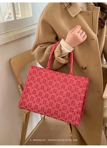 Close-up of red Chinese wedding tote bag with Xi character jacquard pattern