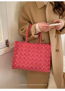 Macro detail of red bridal tote bag featuring traditional Chinese Xi character patterns