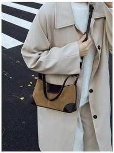 Retro brown suede underarm bag styled with a beige trench coat for a winter look