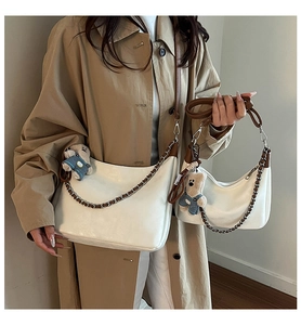Détail d'un ensemble de deux sacs cabas en cuir PU beige avec bandoulières marron et ours