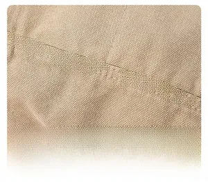 Close-up of khakhi canvas fabric texture showing precision stitching and durable material