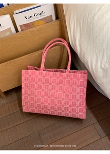 Detailed macro of pink woven tote bag featuring repeating Chinese Double Happiness patterns