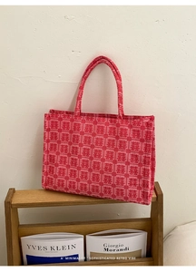 Detailed macro view of red canvas tote bag with traditional Chinese Double Happiness patterns