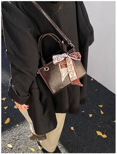 Deep coffee glossy leather crossbody bag with silk scarf detail and branding