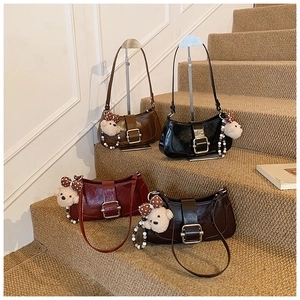 Detail shot of four elegant shoulder bags with metal buckles and cute bear charms