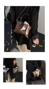 Detail of vintage brown leather tote bag with silk scarf handle and logo print