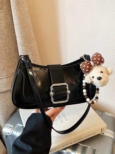 Glossy black faux leather baguette bag with silver buckle and cute plush bear charm