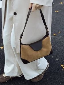 Retro khaki suede and brown leather hobo bag for women in a street style fall setting