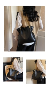 Macro detail of black quilted leather bucket bag featuring elegant gold chain strap