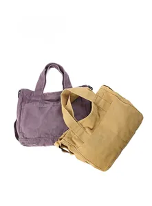Detail of purple and ginger canvas tote bags with double reinforced handles and side pockets