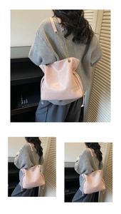 Detail of pink drawstring bucket bag with geometric stitching and chain strap