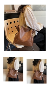 Close-up of brown PU leather tote with quilted stitching and gold chain strap detail