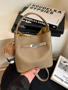 Vintage brown pebbled leather bucket bag with silver lock and plush bear charm accent