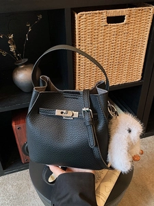 Black pebbled leather bucket bag with silver clasp and cute plush bunny charm