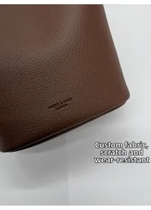 Detail of scratch-resistant brown lychee grain leather with MIQIER brand logo