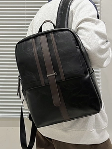 Fashionable black PU leather backpack for women with brown straps and metal buckles