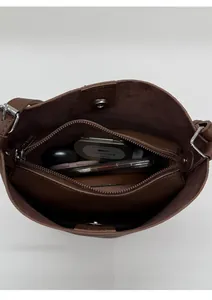 Interior view of the dark brown leather bucket bag showing compartments and daily essentials