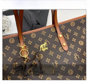 Detail of vintage monogram tote bag featuring golden kangaroo hardware and brand pattern