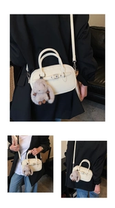 Minimalist beige square handbag with silver buckle and plush rabbit charm on side