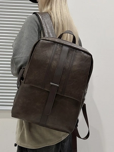 Dark brown vintage PU leather backpack with minimalist flap design and texture