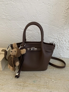 Brown litchi leather tote bag with silver twist lock and cute teddy bear charm detail
