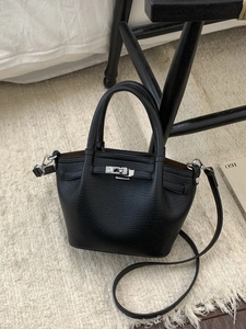 Black lychee pattern leather tote bag with silver twist lock and crossbody strap