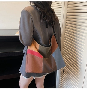 Detail of color-block tote bag featuring contrast stitching and large capacity design