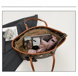 Spacious interior of a vintage monogram tote bag holding a tablet and daily essentials