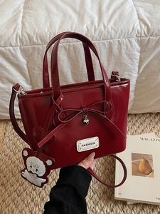 Vintage burgundy patent leather bucket bag with a bow and cute bear charm
