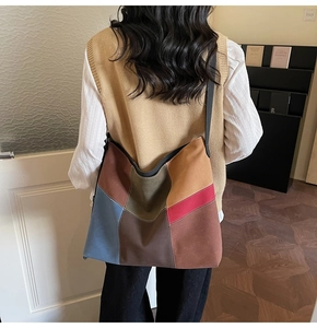 Detailed view of a retro patchwork tote bag with multicolored blocks and a black strap