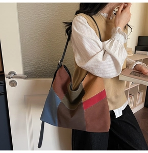 Close-up of a large multi-color patchwork hobo bag featuring matte suede-like texture