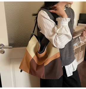 Detail of multi-color hobo bag in beige and coffee brown with matte texture