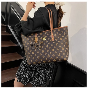 Brown monogram tote bag featuring a leather handle and a cute dog-shaped bag charm