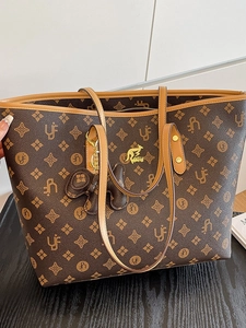 Vintage monogram tote bag in dark brown leather with gold kangaroo logo and butterfly charm