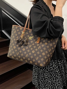 Vintage monogram tote bag with gold kangaroo logo and dog charm shown on shoulder