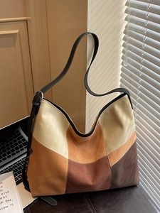 Minimalist color-block canvas tote bag with contrast stitching and shoulder strap