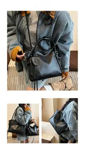 Detail view of black soft matte leather tote bag featuring a round magnetic clasp accent