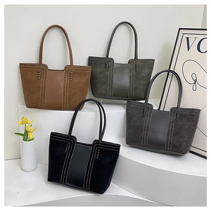 Detail view of large patchwork tote bags in four colors with contrast white stitching