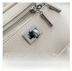 Detail of lychee pattern beige leather texture with silver zipper and rotary metal lock