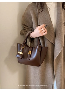 Minimalist dark brown retro bucket bag with gold lock buckle and mini side pouch