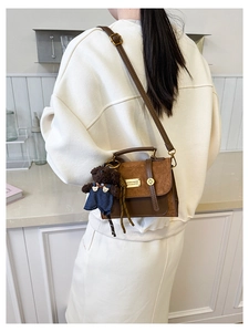 Brown leather crossbody bag with suede patchwork and a cute teddy bear charm
