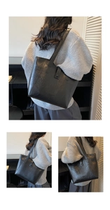 Detail of black tote bag showing vintage pleated texture and Fashion trend Studio logo